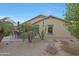 Charming backyard with a covered patio, built in bar, lush desert landscaping, and a privacy fence at 3519 S 185Th Dr, Goodyear, AZ 85338