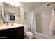 Cozy bathroom featuring a shower-tub combo, single sink vanity, and neutral color scheme at 3519 S 185Th Dr, Goodyear, AZ 85338