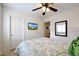 Bedroom featuring a bed, a ceiling fan, and a TV mounted on the wall, creating a cozy and functional space at 3519 S 185Th Dr, Goodyear, AZ 85338