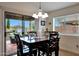 Cozy dining area featuring a dark wood table and chairs, with a view to the patio through sliding glass doors at 3519 S 185Th Dr, Goodyear, AZ 85338