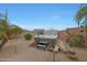 Relaxing backyard featuring a luxurious hot tub with flagstone hardscaping, lush palms and desert flora at 3519 S 185Th Dr, Goodyear, AZ 85338