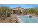 Resort style backyard features a hot tub, covered patio, outdoor seating, and desert landscaping at 3519 S 185Th Dr, Goodyear, AZ 85338