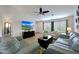 Bright living room featuring comfortable seating, a ceiling fan, and a modern entertainment setup with a large TV at 3519 S 185Th Dr, Goodyear, AZ 85338