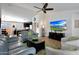 Open-concept living room with stylish furnishings, a ceiling fan, and a view into the kitchen area at 3519 S 185Th Dr, Goodyear, AZ 85338