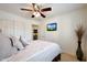 Inviting bedroom with plush bedding, ceiling fan, and wall-mounted TV for added relaxation at 3519 S 185Th Dr, Goodyear, AZ 85338