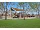 Community playground with slides, climbing structures, and shade canopy for a fun and safe play environment at 3519 S 185Th Dr, Goodyear, AZ 85338