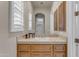 Bathroom vanity with detailed tile work on countertop, light wooden cabinets, and a large mirror at 3616 E Kachina Dr, Phoenix, AZ 85044