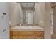 Bathroom vanity featuring detailed tile work on countertop and mirror with tan walls and cabinet at 3616 E Kachina Dr, Phoenix, AZ 85044