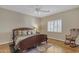 Serene bedroom featuring a comfortable bed, a cozy rocking chair, and natural light from shuttered windows at 3616 E Kachina Dr, Phoenix, AZ 85044