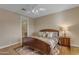 Comfortable bedroom featuring a wooden bed frame, a ceiling fan, and a view of the en suite bathroom at 3616 E Kachina Dr, Phoenix, AZ 85044