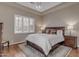 Bedroom with neutral walls, wood floors, and a large window with white blinds at 3616 E Kachina Dr, Phoenix, AZ 85044