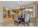 Dining room adjacent to kitchen, featuring chandelier and tiled floors at 3616 E Kachina Dr, Phoenix, AZ 85044