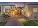 Welcoming front entrance with an ornate iron gate, arched doorway and desert landscaping with rock accents at 3616 E Kachina Dr, Phoenix, AZ 85044