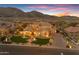 Stunning sunset view of an estate home featuring desert landscaping, a grand entrance and multiple garage bays at 3616 E Kachina Dr, Phoenix, AZ 85044