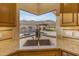 Kitchen sink with a view of the pool and mountains at 3616 E Kachina Dr, Phoenix, AZ 85044