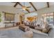 Elegant living room with high ceilings, wooden beams, and stylish furniture, creating a luxurious space at 3616 E Kachina Dr, Phoenix, AZ 85044