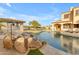 Luxury pool area with stone accents, a rock waterfall, and multiple seating areas, ideal for outdoor entertaining at 3616 E Kachina Dr, Phoenix, AZ 85044