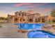 This backyard features a uniquely shaped pool and jacuzzi with patio and barbecue for entertaining at 3616 E Kachina Dr, Phoenix, AZ 85044