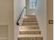 Beautiful staircase featuring mosaic tile accents, a sleek handrail, and recessed lighting at 3616 E Kachina Dr, Phoenix, AZ 85044