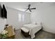 This bedroom features neutral tones, a ceiling fan, and lots of natural light at 40481 W Desert Fairways Dr, Maricopa, AZ 85138