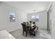 Bright dining room with a wooden table, upholstered chairs, a bench, and natural light at 40481 W Desert Fairways Dr, Maricopa, AZ 85138