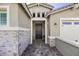 Close-up of front door and stone accents on facade at 40481 W Desert Fairways Dr, Maricopa, AZ 85138