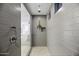 Tiled walk-in shower, featuring mosaic tile floor, and a rain shower head at 40481 W Desert Fairways Dr, Maricopa, AZ 85138