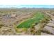 High aerial view of a desert golf community showcasing the winding fairways and desert landscaping at 42105 N Golf Crest Rd, Anthem, AZ 85086