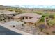 Elevated view of the house highlighting mature landscape, desert plants, tile roof, and golf course at 42105 N Golf Crest Rd, Anthem, AZ 85086