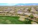 Community aerial view showing neighborhood with lush desert plants, golf course, and mountain views at 42105 N Golf Crest Rd, Anthem, AZ 85086