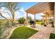 Beautiful outdoor space featuring a built in bbq, brick patio, lush desert plants, and a wood pergola at 42105 N Golf Crest Rd, Anthem, AZ 85086