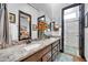 Well-lit bathroom featuring granite counters, double sinks, tiled backsplash, decorative fixtures, and a glass-enclosed shower at 42105 N Golf Crest Rd, Anthem, AZ 85086