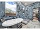 Elegant bathroom featuring a freestanding tub, walk-in shower with marble tiling, a window, and an open access closet at 42105 N Golf Crest Rd, Anthem, AZ 85086