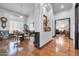 Open-concept dining room with hardwood floors, paneled walls and views to another sitting room at 42105 N Golf Crest Rd, Anthem, AZ 85086