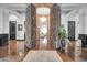 Grand foyer featuring hardwood floors, stone columns, a crystal chandelier and views into the living room at 42105 N Golf Crest Rd, Anthem, AZ 85086