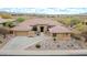 Eye-level view of the home showcasing mature landscape, desert plants, tile roof, and entry at 42105 N Golf Crest Rd, Anthem, AZ 85086