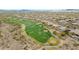 Aerial view showcasing the golf course, sand traps, fairways, green grass, and desert plants at 42105 N Golf Crest Rd, Anthem, AZ 85086