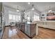 Modern kitchen with a stainless-steel dishwasher, wood cabinets and views to the living room at 42105 N Golf Crest Rd, Anthem, AZ 85086