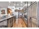 Well-equipped kitchen with modern appliances, wood cabinets and a view of the living area at 42105 N Golf Crest Rd, Anthem, AZ 85086