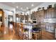 Large kitchen featuring stainless steel appliances, custom cabinets, and a marble island with bar seating at 42105 N Golf Crest Rd, Anthem, AZ 85086