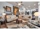 Open living room with stylish furniture, a stone accent wall and views into the kitchen at 42105 N Golf Crest Rd, Anthem, AZ 85086