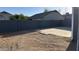 This backyard features a concrete patio section with a privacy wall surrounding the yard at 4231 E Carter Dr, Phoenix, AZ 85042