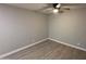 This is a spacious bedroom with light walls, updated flooring, and a ceiling fan at 4231 E Carter Dr, Phoenix, AZ 85042