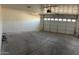 This is a garage that has an automatic door with windows and a concrete floor at 4231 E Carter Dr, Phoenix, AZ 85042