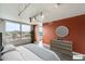 Bedroom showcasing a large window with outdoor views, complemented by a stylish dresser and decor at 535 W Thomas Rd # 410, Phoenix, AZ 85013