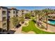 An aerial view showcases a landscaped community with verdant lawns and palm tree-lined paths at 5350 E Deer Valley Dr # 4408, Phoenix, AZ 85054