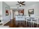 Bright dining area features a modern ceiling fan, adjacent to an open kitchen with dark wood floors at 5350 E Deer Valley Dr # 4408, Phoenix, AZ 85054