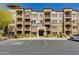 Beautiful multi-story condo building with a stone facade, covered balconies, and well-maintained landscaping at 5350 E Deer Valley Dr # 4408, Phoenix, AZ 85054