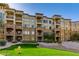 Multi-story building with stacked balconies, stone accents, and well-maintained landscaping at 5350 E Deer Valley Dr # 4408, Phoenix, AZ 85054