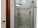 Updated shower with glass door and neutral-toned tiles, complemented by wooden door frame at 5350 E Deer Valley Dr # 4408, Phoenix, AZ 85054